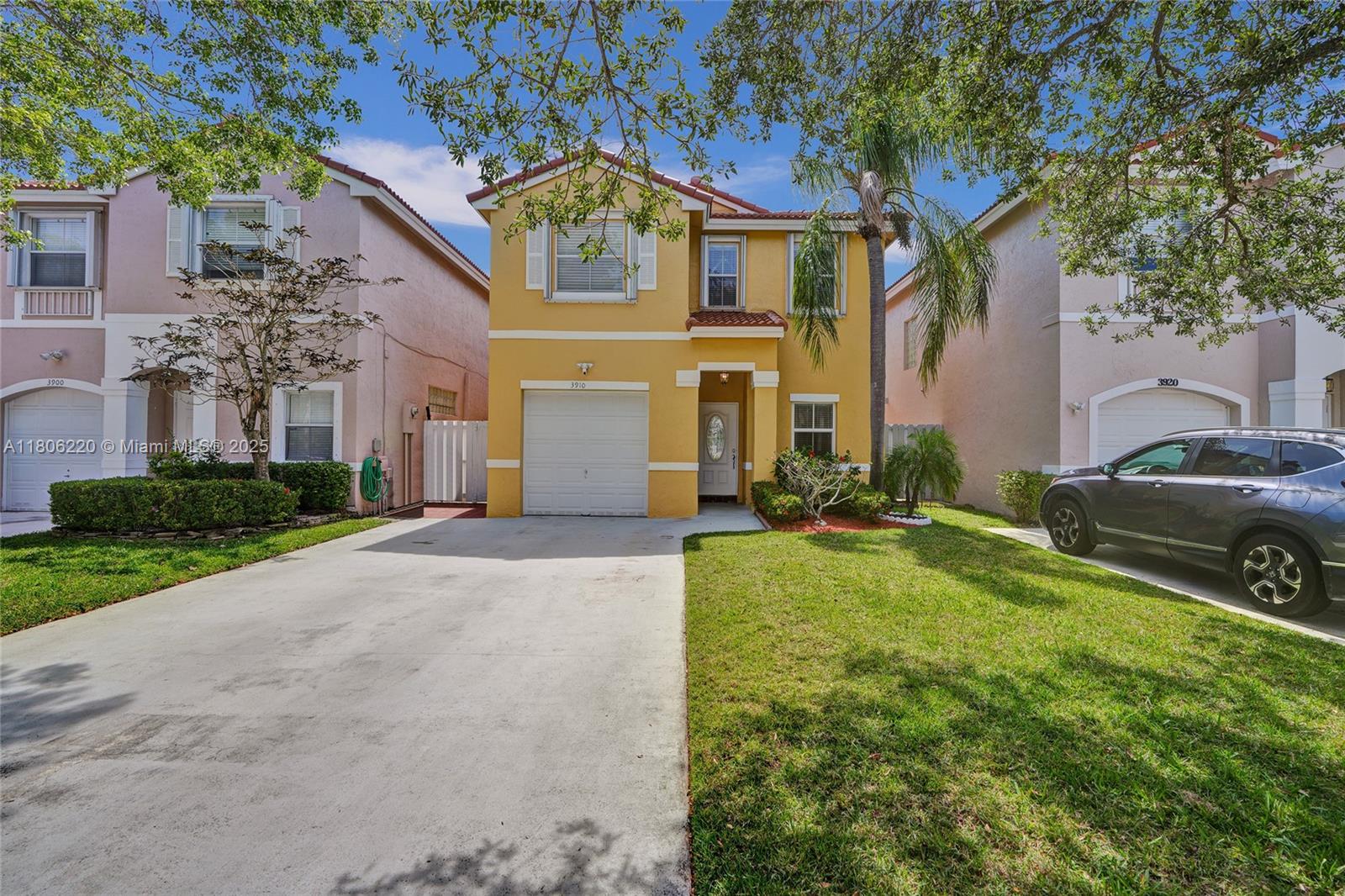 3910 Fern Forest Road Cooper City, FL 33026 - Photo 2 of 38 a front view of a house with a yard
