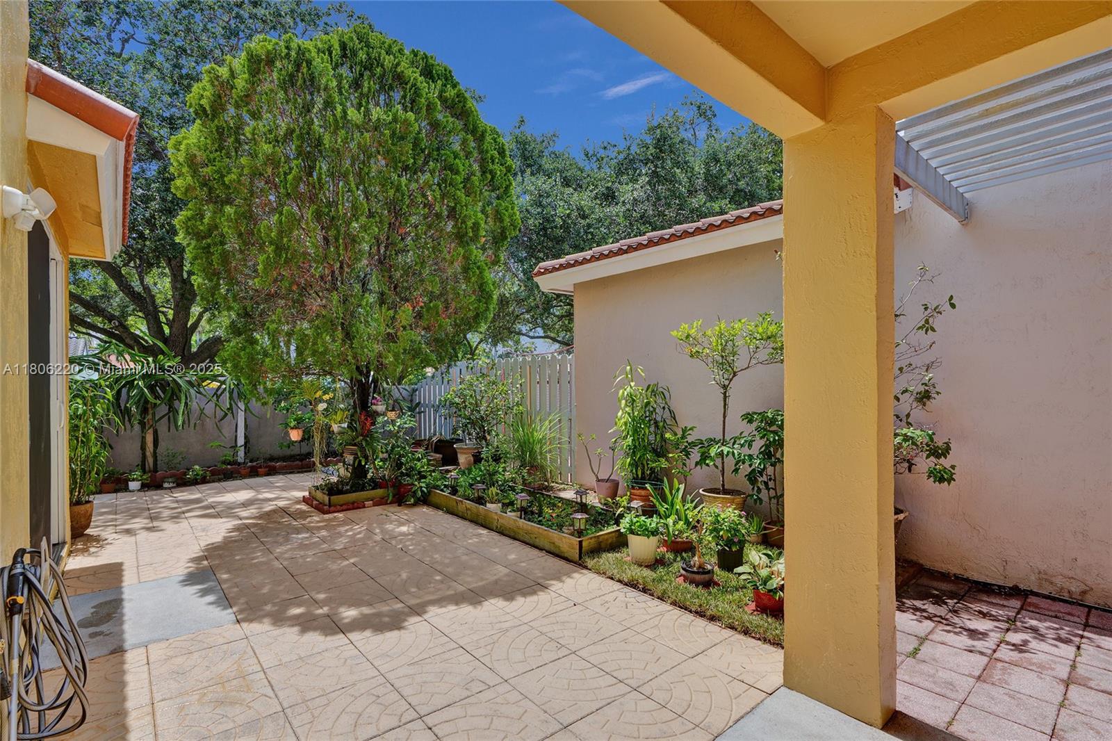 3910 Fern Forest Road Cooper City, FL 33026 - Photo 27 of 38 a view of a backyard with potted plants