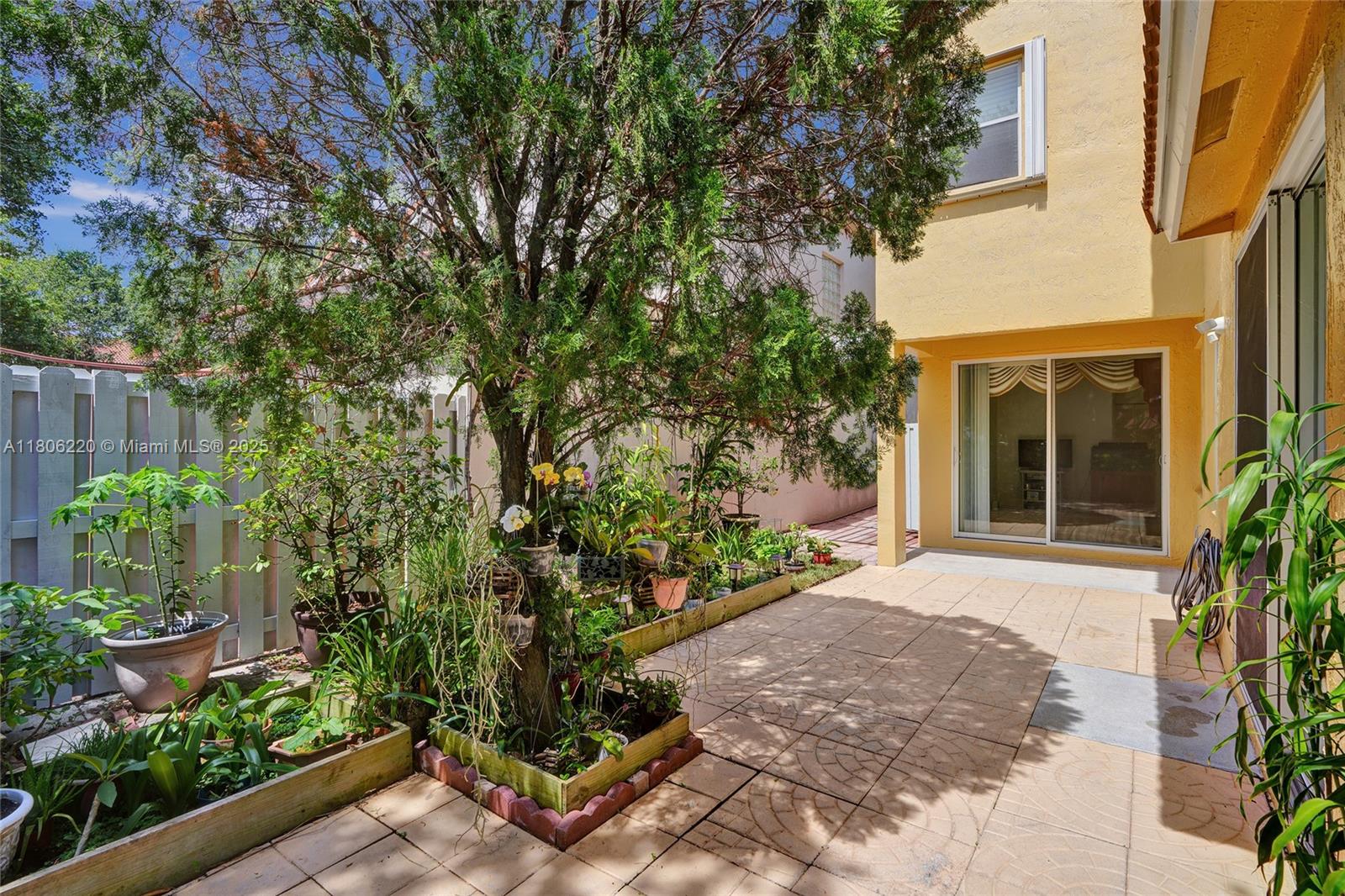 3910 Fern Forest Road Cooper City, FL 33026 - Photo 29 of 38 a front view of a house with a yard and potted plants