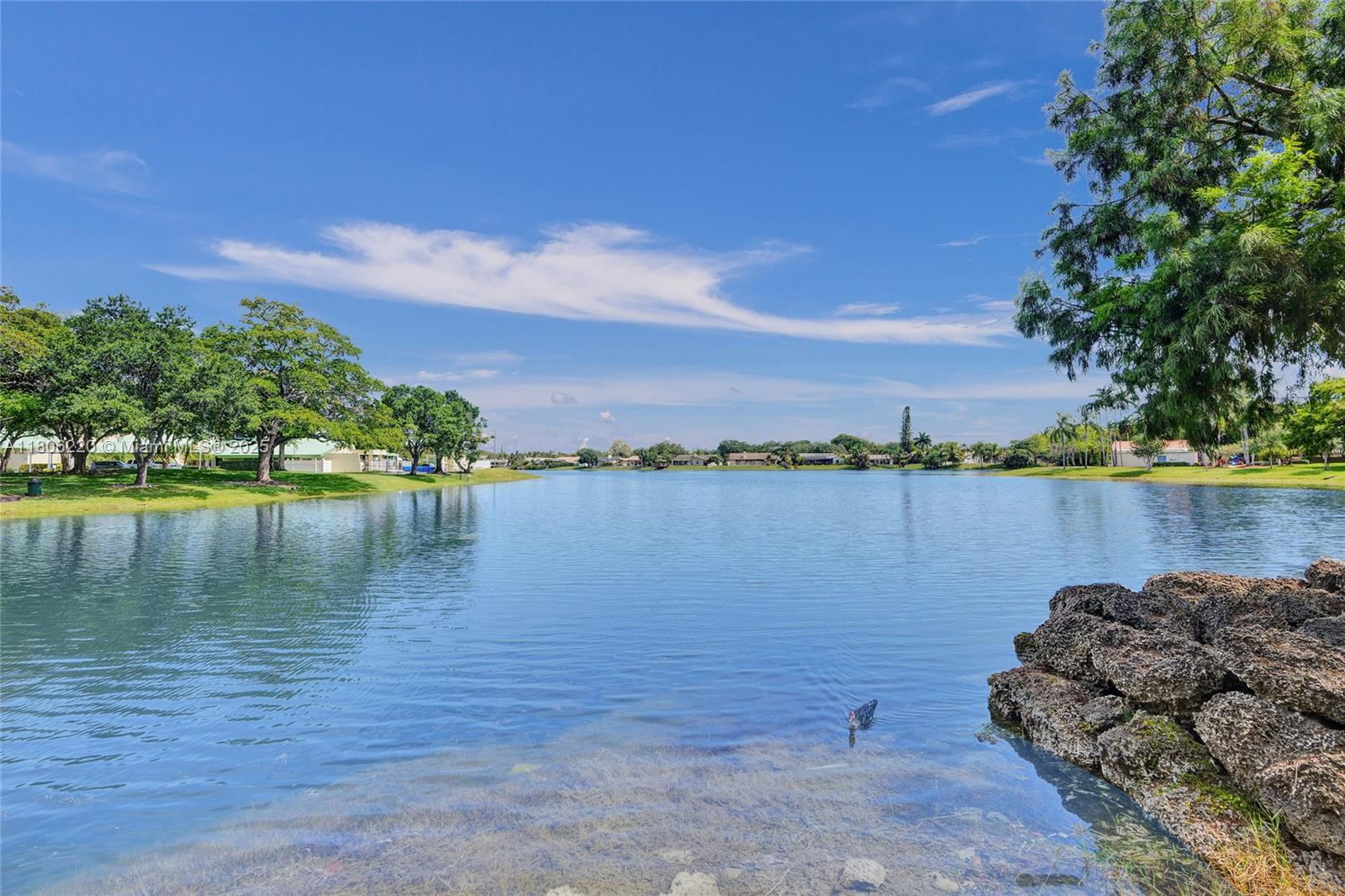 3910 Fern Forest Road Cooper City, FL 33026 - Photo 33 of 38 a view of a lake with houses in the back
