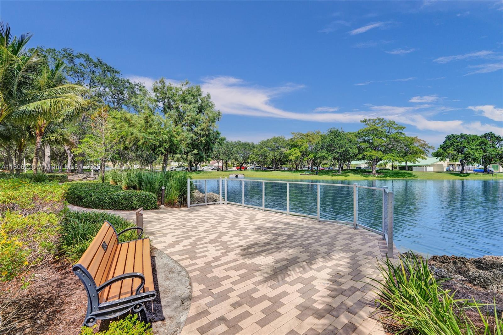 3910 Fern Forest Road Cooper City, FL 33026 - Photo 34 of 38 a view of swimming pool with a yard and a bench