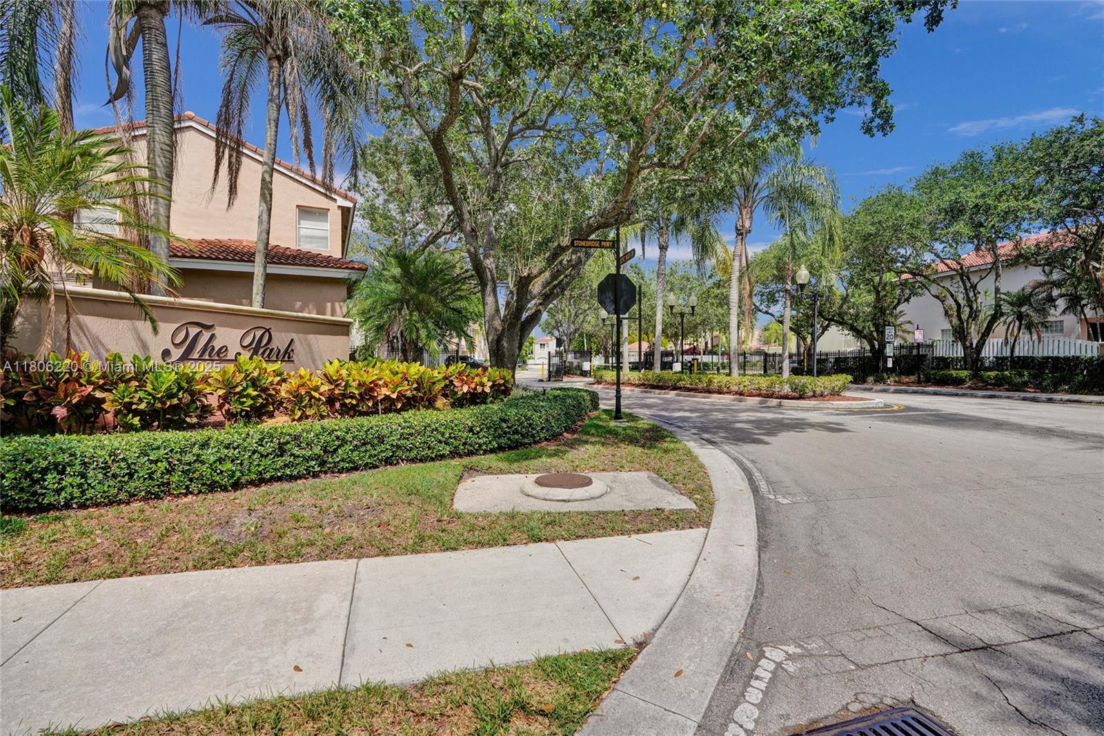 3910 Fern Forest Road Cooper City, FL 33026 - Photo 4 of 38 a park view with large trees and flower plants