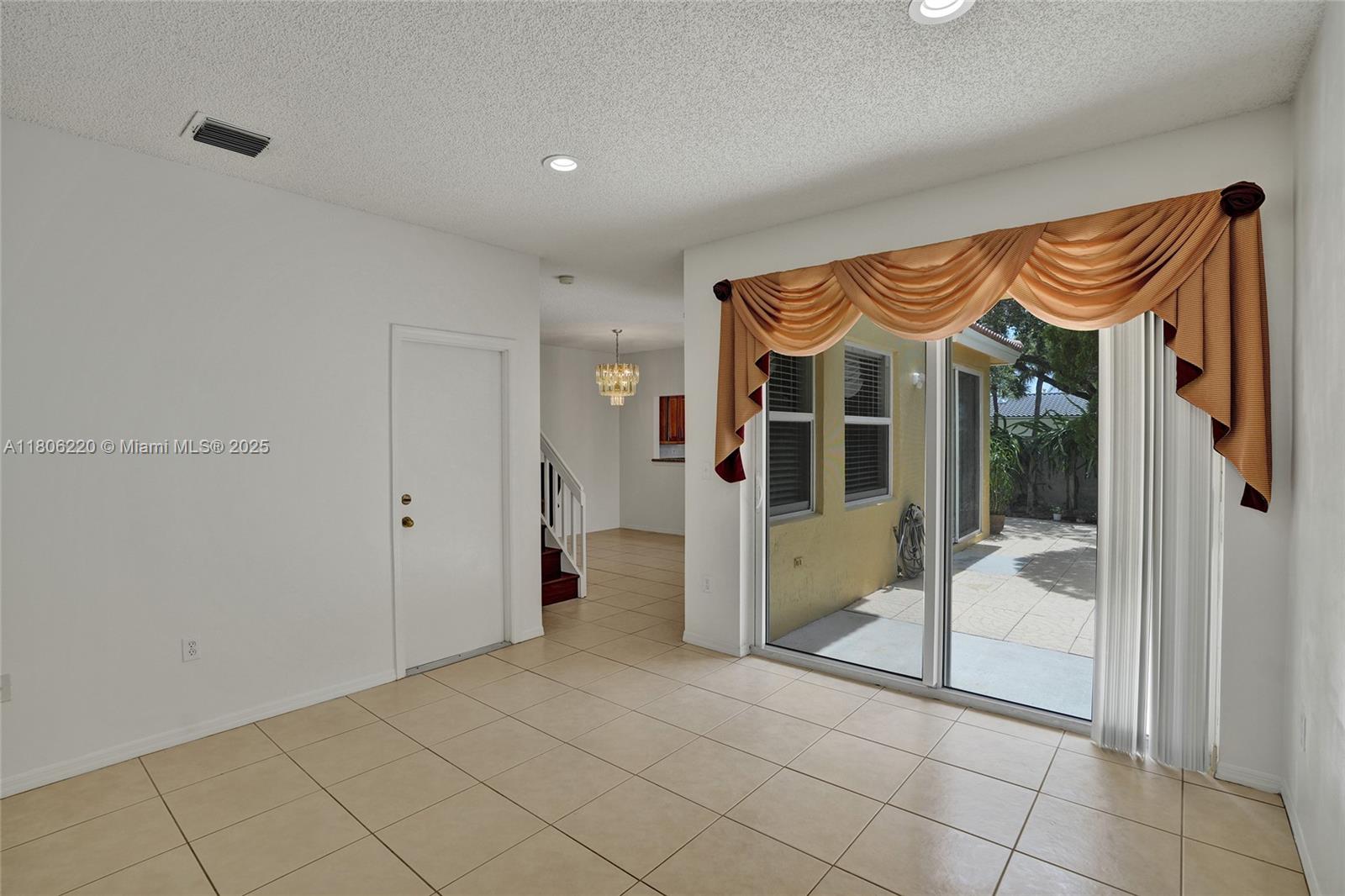 3910 Fern Forest Road Cooper City, FL 33026 - Photo 6 of 38 a view of an entryway with wooden floor and a livingroom