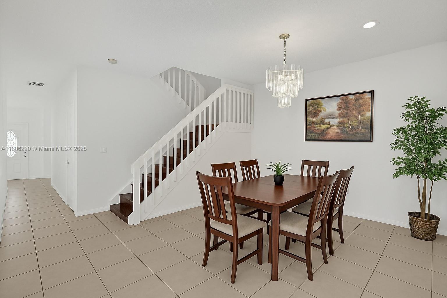 3910 Fern Forest Road Cooper City, FL 33026 - Photo 10 of 38 a view of a dining room with furniture