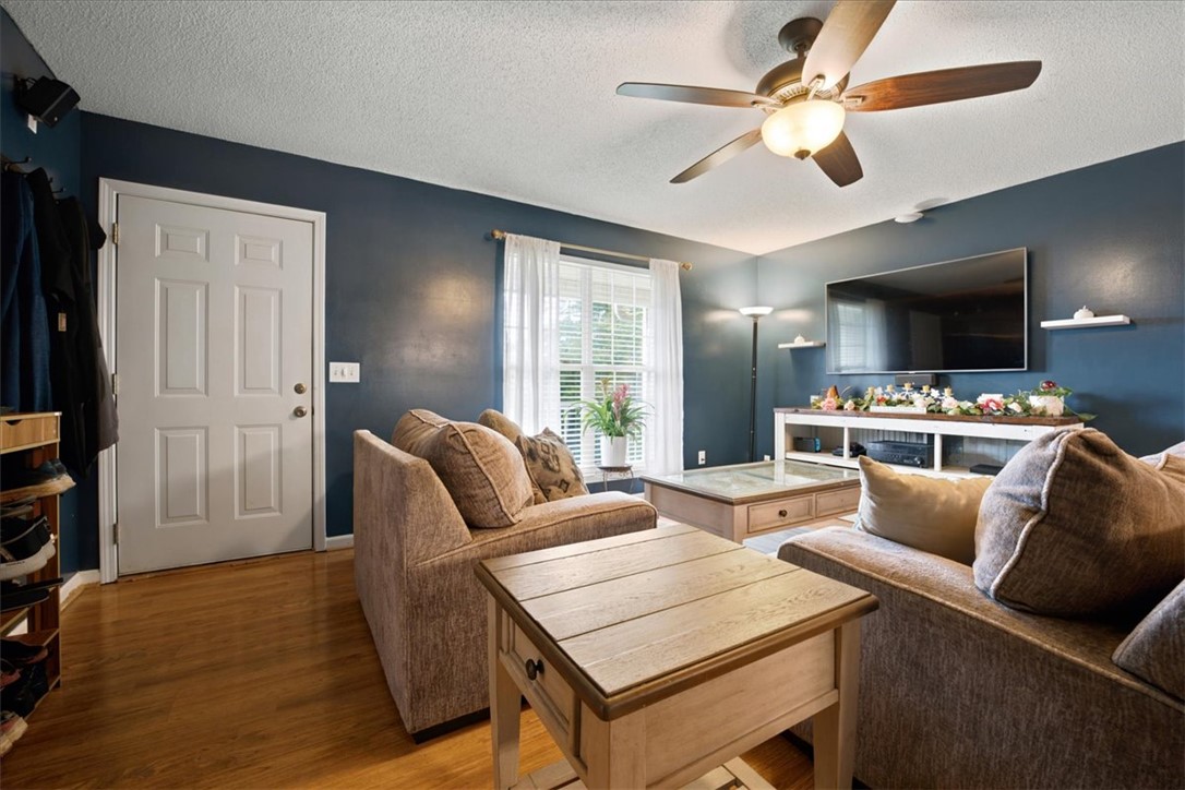 520 Sharon Lane Seneca, SC 29678 - Photo 7 of 48 A comforting living space features hardwood flooring and a ceiling fan, inviting relaxation.
