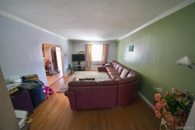 a living room with furniture and a mirror