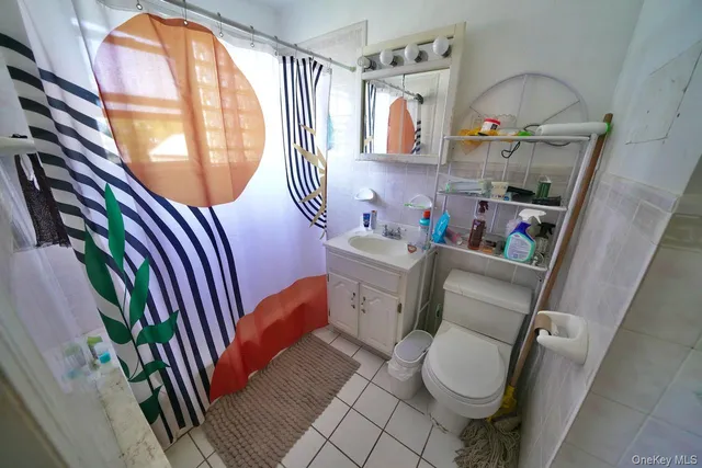 a bathroom with a sink mirror vanity and toilet