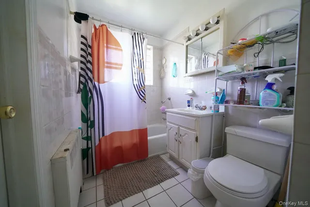 a bathroom with a sink toilet vanity and window