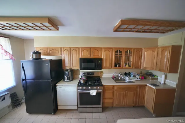 a kitchen with a refrigerator and a stove top oven