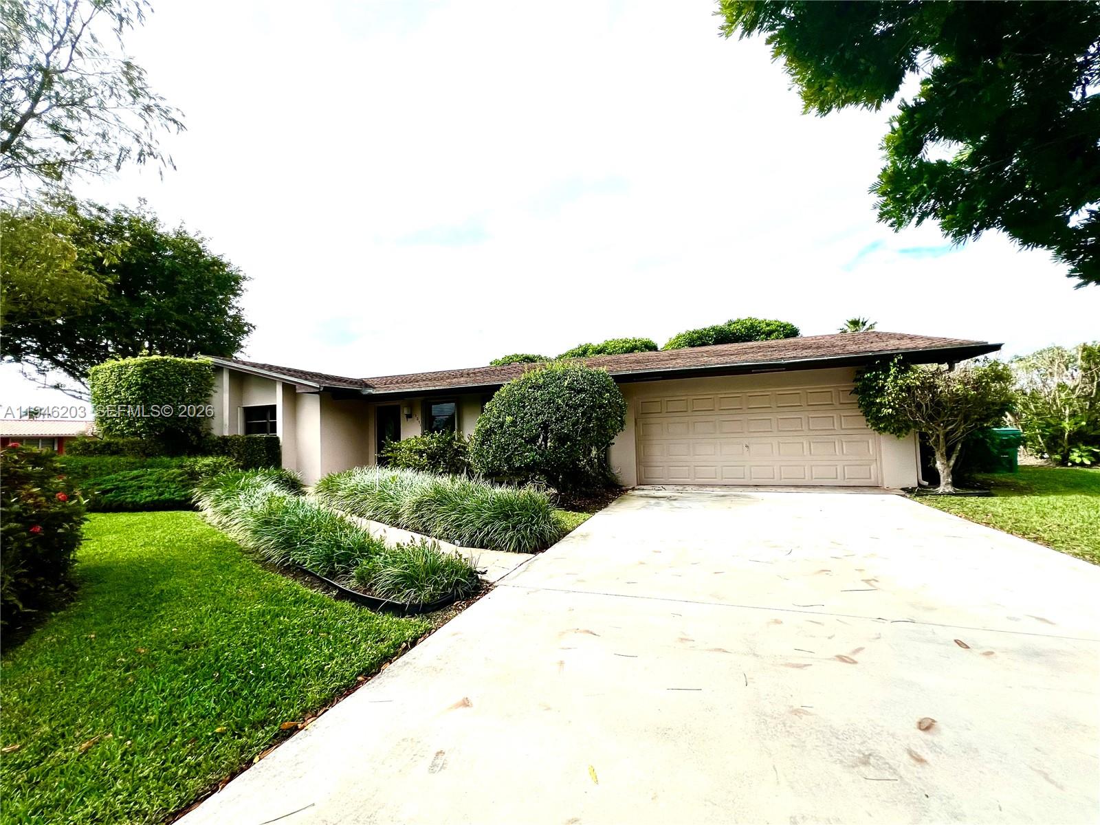 13100 Southwest 108th Place Miami, FL 33176 - Photo 1 of 16 a front view of a house with a yard