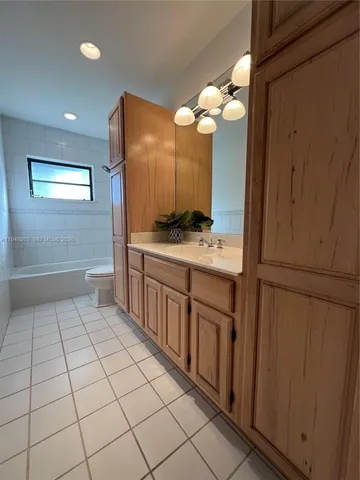 a view of a big room with wooden floor and a ceiling fan