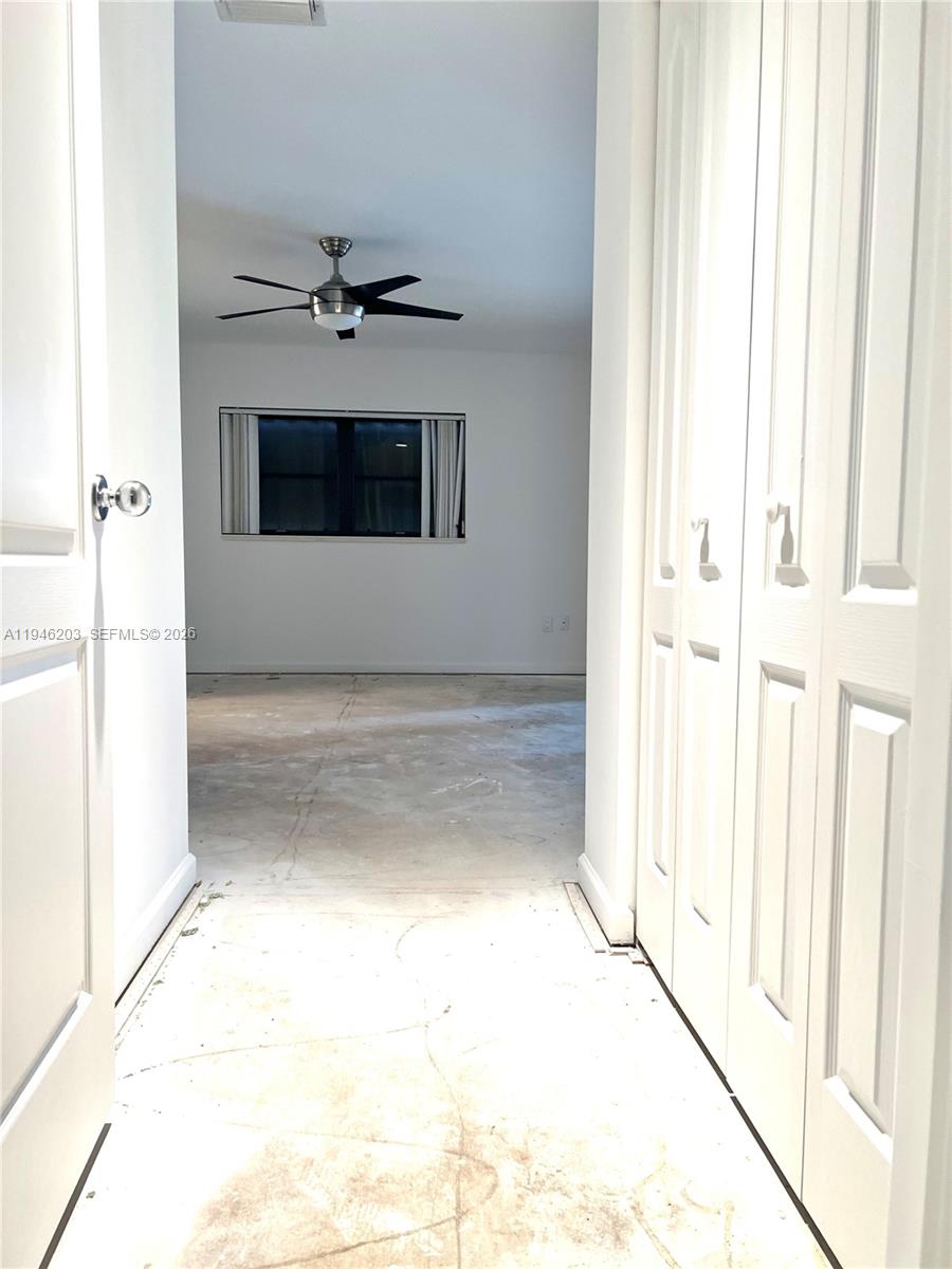 13100 Southwest 108th Place Miami, FL 33176 - Photo 12 of 16 a view of a hallway with a chandelier