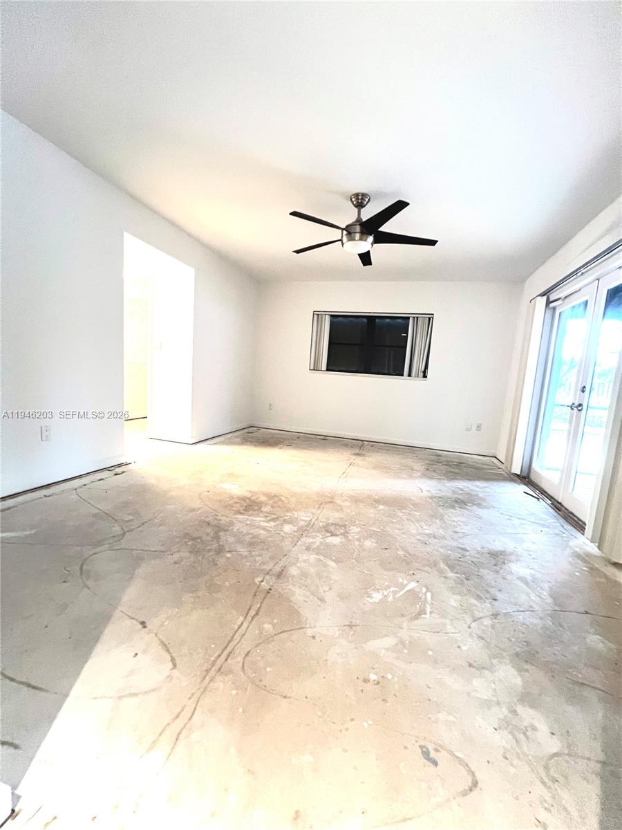 13100 Southwest 108th Place Miami, FL 33176 - Photo 13 of 16 a view of a big room with wooden floor and a ceiling fan