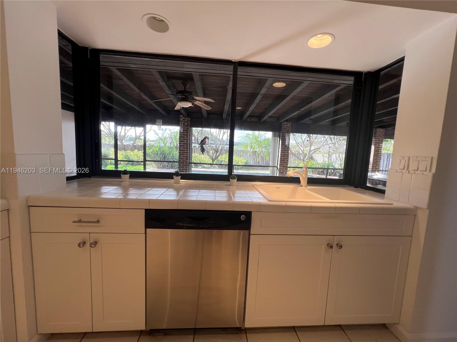 13100 Southwest 108th Place Miami, FL 33176 - Photo 6 of 16 a kitchen with a sink and large window