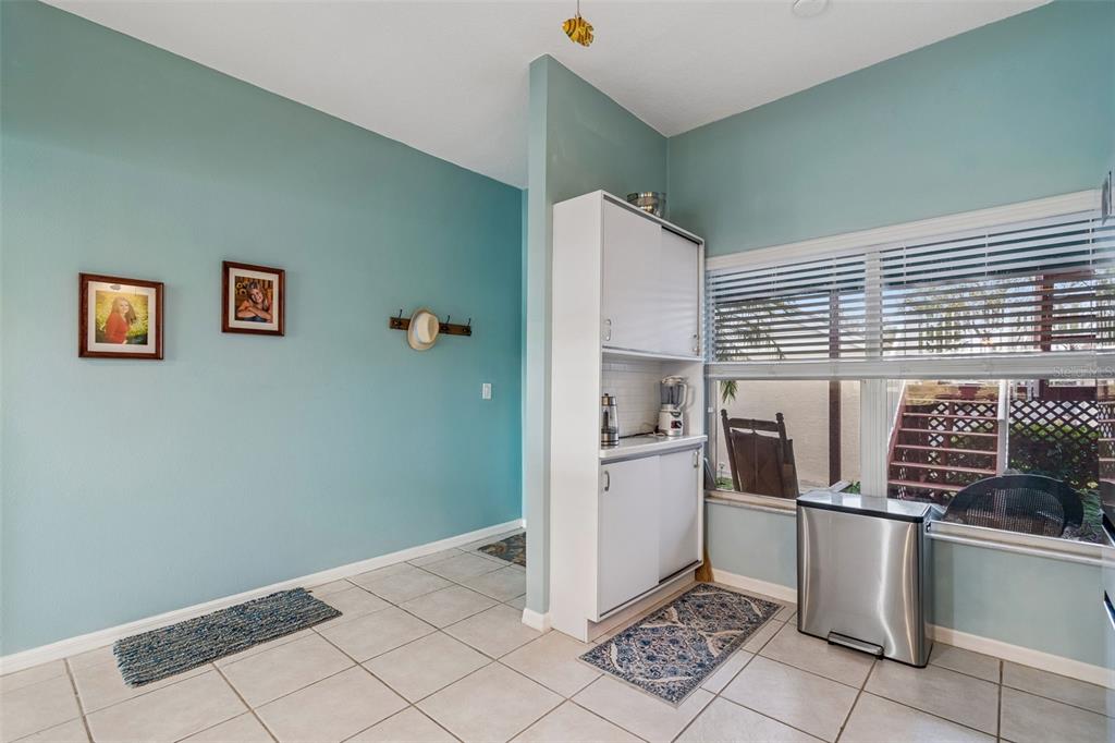 6499 99th Way North, Unit 18B St. Petersburg, FL 33708 - Photo 11 of 98 a kitchen with granite countertop a refrigerator and a stove top oven