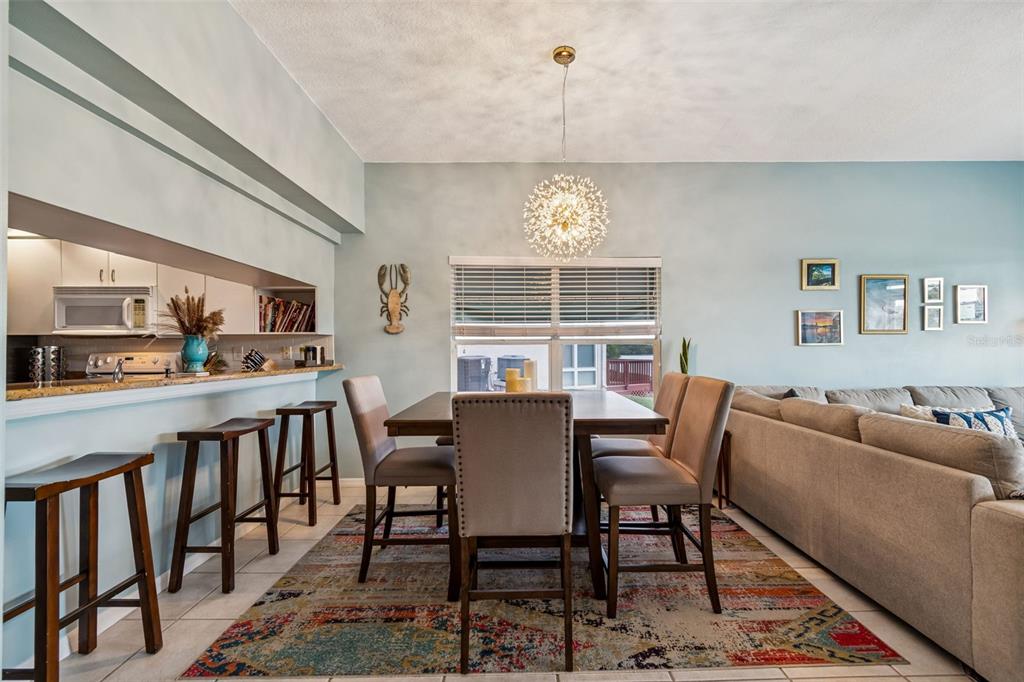 6499 99th Way North, Unit 18B St. Petersburg, FL 33708 - Photo 16 of 98 a view of a dining room with furniture window and wooden floor