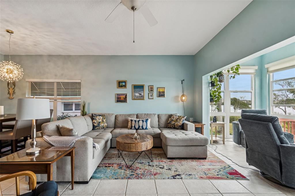 6499 99th Way North, Unit 18B St. Petersburg, FL 33708 - Photo 20 of 98 a living room with furniture fireplace and a large window