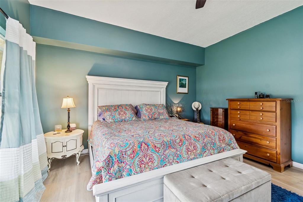 6499 99th Way North, Unit 18B St. Petersburg, FL 33708 - Photo 29 of 98 a bedroom with a bed and wooden floor