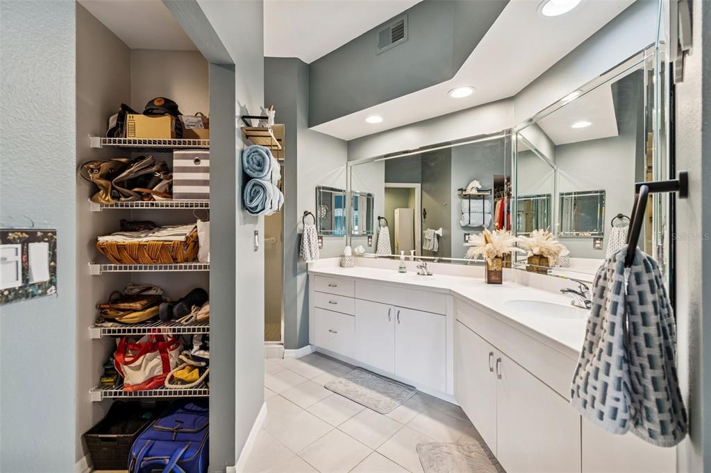6499 99th Way North, Unit 18B St. Petersburg, FL 33708 - Photo 32 of 98 a spacious bathroom with a double vanity sink and a mirror