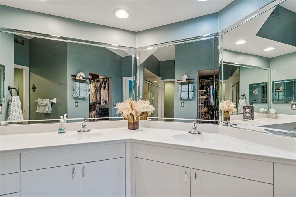 6499 99th Way North, Unit 18B St. Petersburg, FL 33708 - Photo 33 of 98 a bathroom with double vanity sinks and a mirror