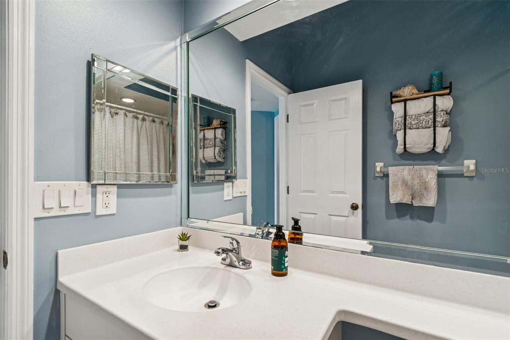6499 99th Way North, Unit 18B St. Petersburg, FL 33708 - Photo 43 of 98 a bathroom with a sink and a mirror