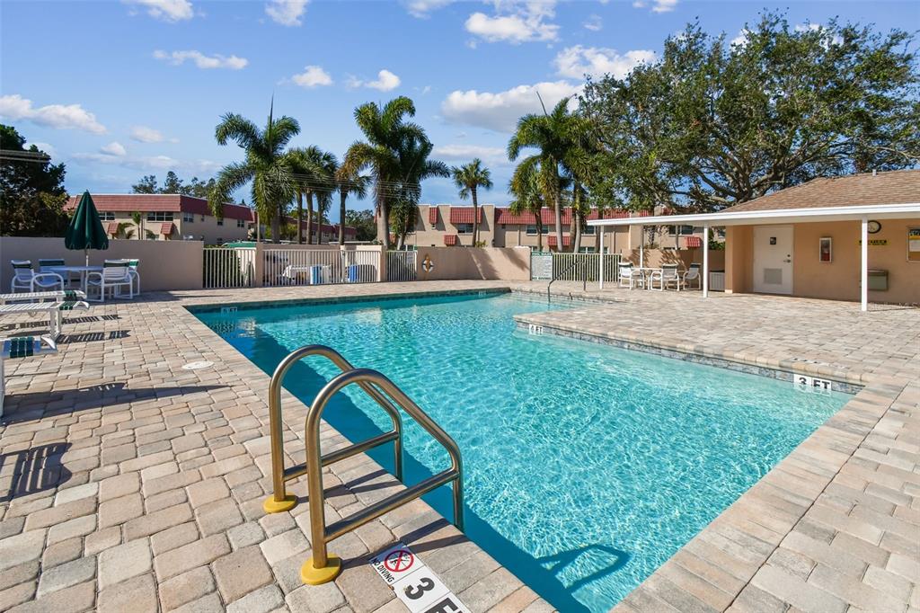 6499 99th Way North, Unit 18B St. Petersburg, FL 33708 - Photo 76 of 98 a view of a house with swimming pool and sitting area