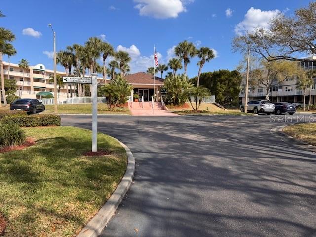 6499 99th Way North, Unit 18B St. Petersburg, FL 33708 - Photo 79 of 98 a front view of a house with a yard