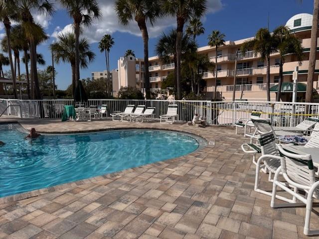 6499 99th Way North, Unit 18B St. Petersburg, FL 33708 - Photo 86 of 98 a view of a swimming pool with a table and chairs