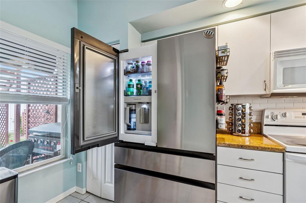 6499 99th Way North, Unit 18B St. Petersburg, FL 33708 - Photo 10 of 98 a kitchen with stainless steel appliances a refrigerator and a sink