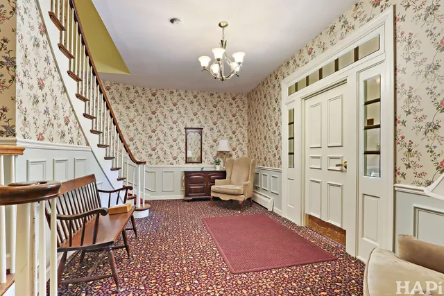 a living room with furniture and a chandelier