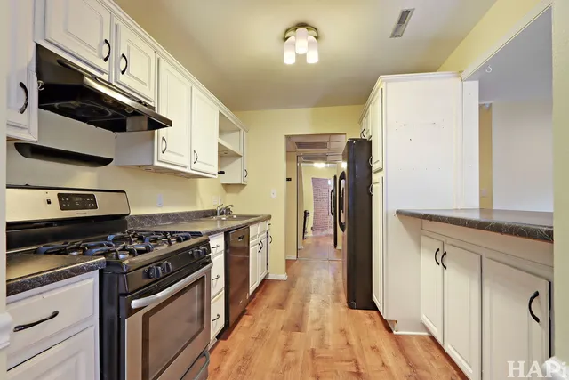 a kitchen with stainless steel appliances granite countertop a stove and a refrigerator