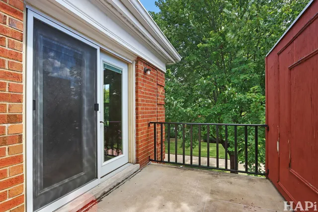 a view of a balcony with a floor to ceiling window and wooden fence