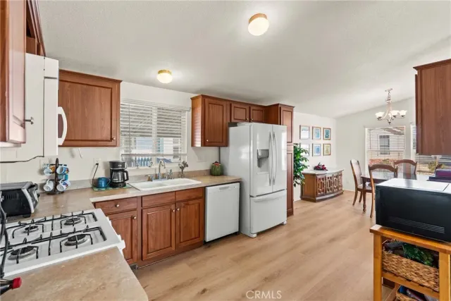 a kitchen with a sink cabinets and wooden floor