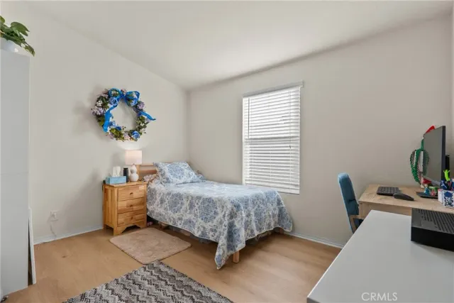 a bedroom with a bed and flat screen tv