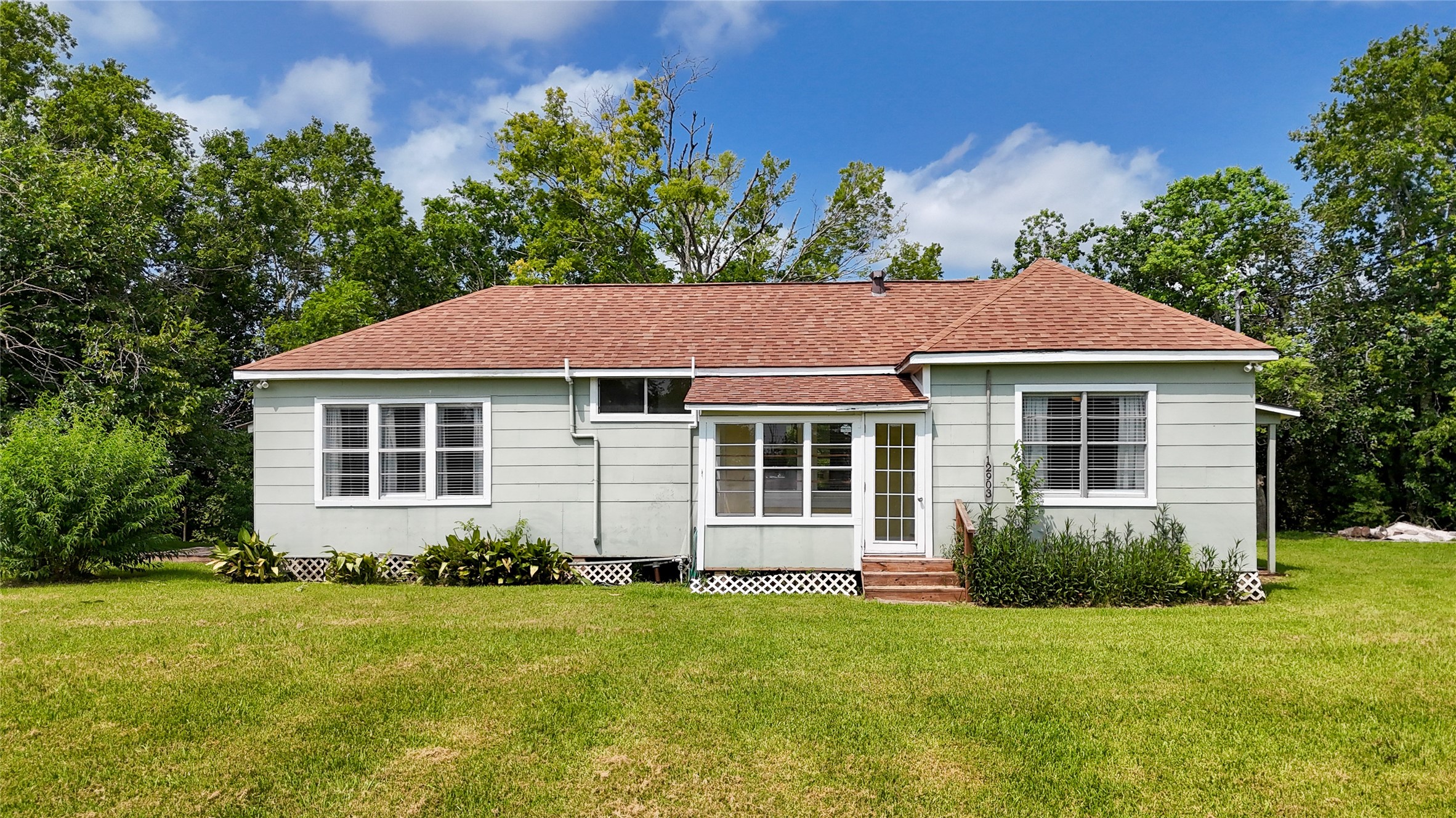 12903 Sandpiper Road Angleton, TX 77515 - Photo 1 of 19 Canal-front living begins with over half an acre of space and mature trees—all just minutes from Bastrop Bayou, Surfside Beach, and everyday conveniences.