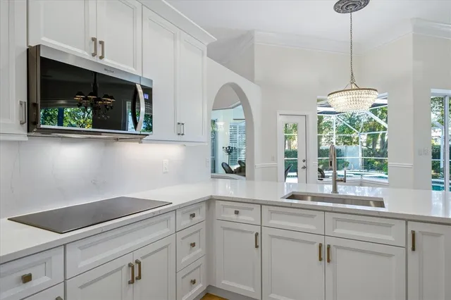 a kitchen with stainless steel appliances white cabinets and a window