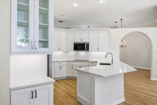 a kitchen with stainless steel appliances granite countertop a sink a stove and a microwave