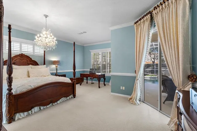 a bedroom with furniture and a chandelier