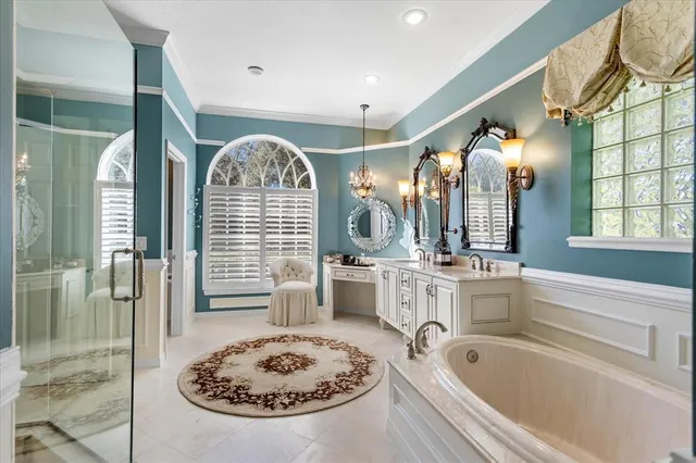 a bathroom with a tub sink and mirror