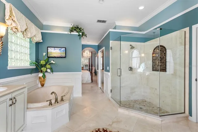 a white bath tub sitting next to a bathroom sink