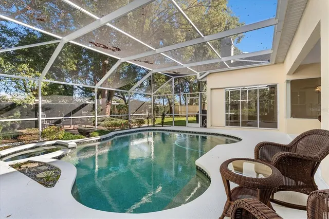 a view of a swimming pool with outdoor seating