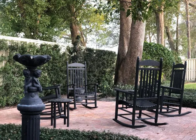 a view of a chairs and table in backyard