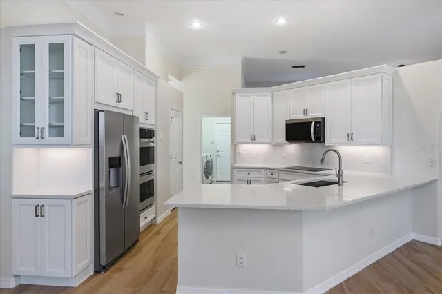 a kitchen with stainless steel appliances granite countertop a refrigerator and a stove