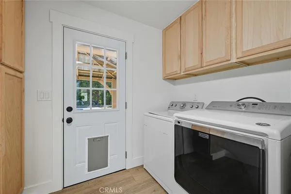 a view of a storage and utility room with washer and dryer
