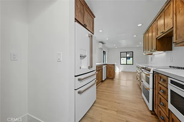 a kitchen with stainless steel appliances a refrigerator and a stove top oven