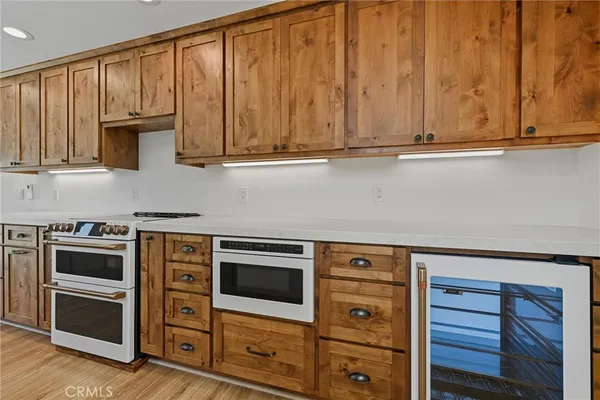 a kitchen with granite countertop cabinets stainless steel appliances and wooden cabinets