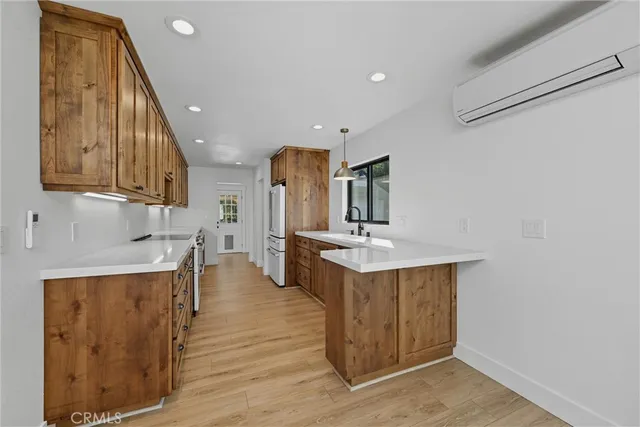 a kitchen with a sink cabinets and wooden floor
