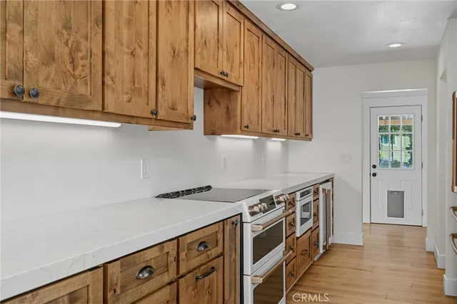 a kitchen with wooden cabinets and a stove top oven