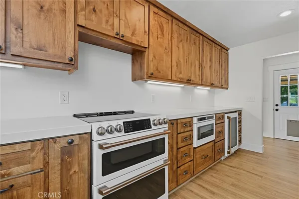 a kitchen with stainless steel appliances granite countertop a stove and a microwave