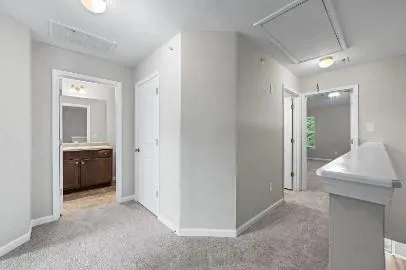 a bathroom with a granite countertop toilet sink and mirror